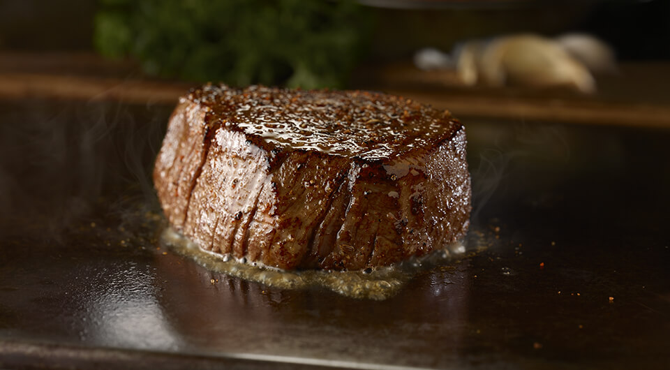The Flo's Filet sizzling on a skillet.