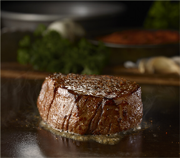 The Flo's Filet sizzling on a skillet.