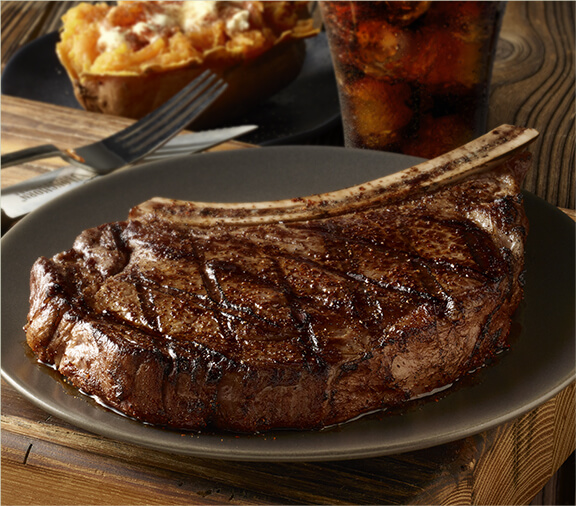 The Outlaw Ribeye, one of LongHorn's juiciest bone-in steaks.