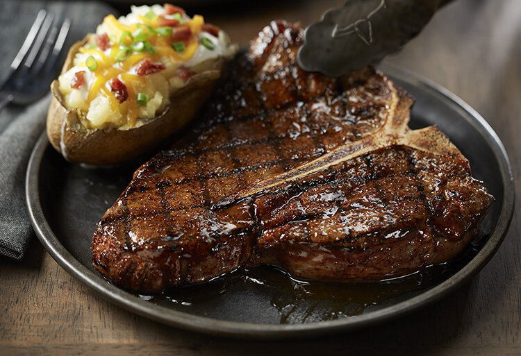 Picture of a steak being placed on a plate